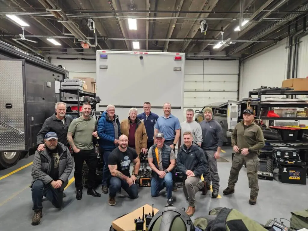 Taken on December 18, 2025, this photo captures an event honoring past and present bomb technicians. Lev appears in the back row, fourth from the left, resting his hand on a modern‑day robot that was not yet available during his career.