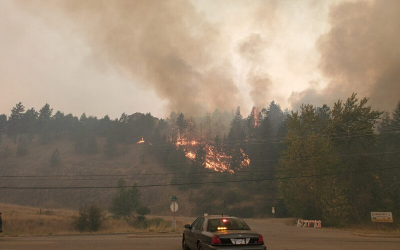 An unmarked RCMP Police Car faces a wildfire in West Kelowna, B.C.