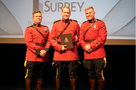 Cst. Attila Szalay (middle) receiving the Officer in Charge Commendation)
